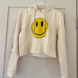 Cropped cream hoodie with smilie face and “no bad days” on sleeves.